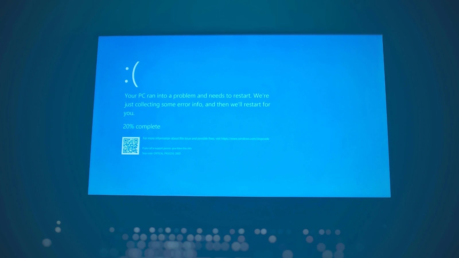 A Windows blue screen error message on a computer monitor