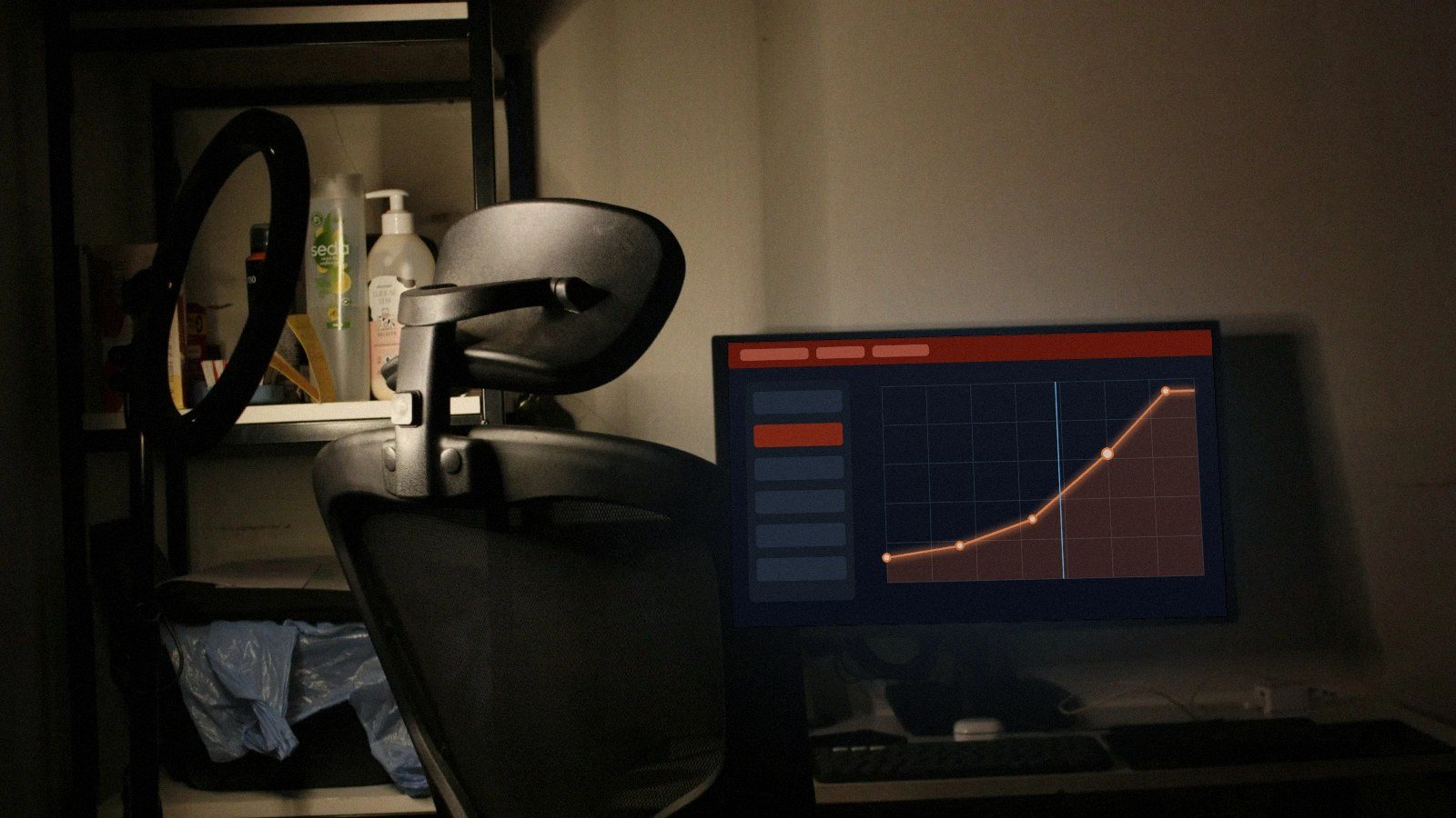 Monitor on a desk showing a fan curve graph in the BIOS