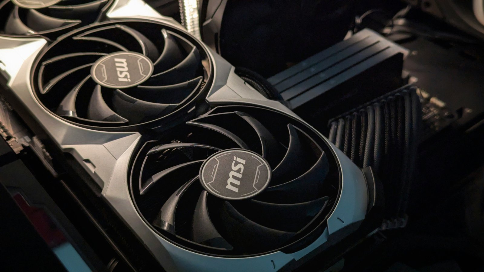 Close-up of a graphics card with two large cooling fans inside a PC