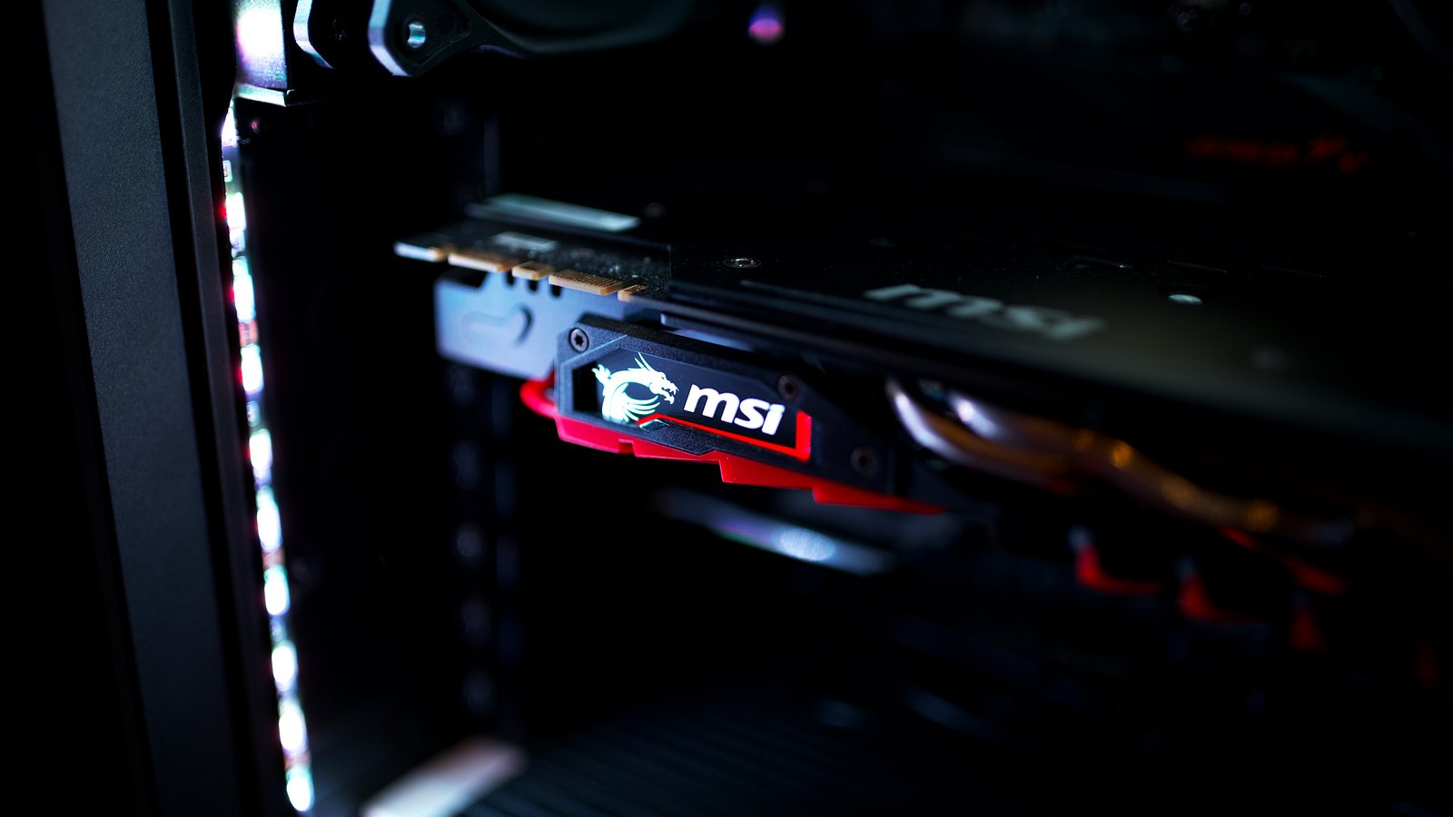 A graphics card glowing red inside a dark PC case