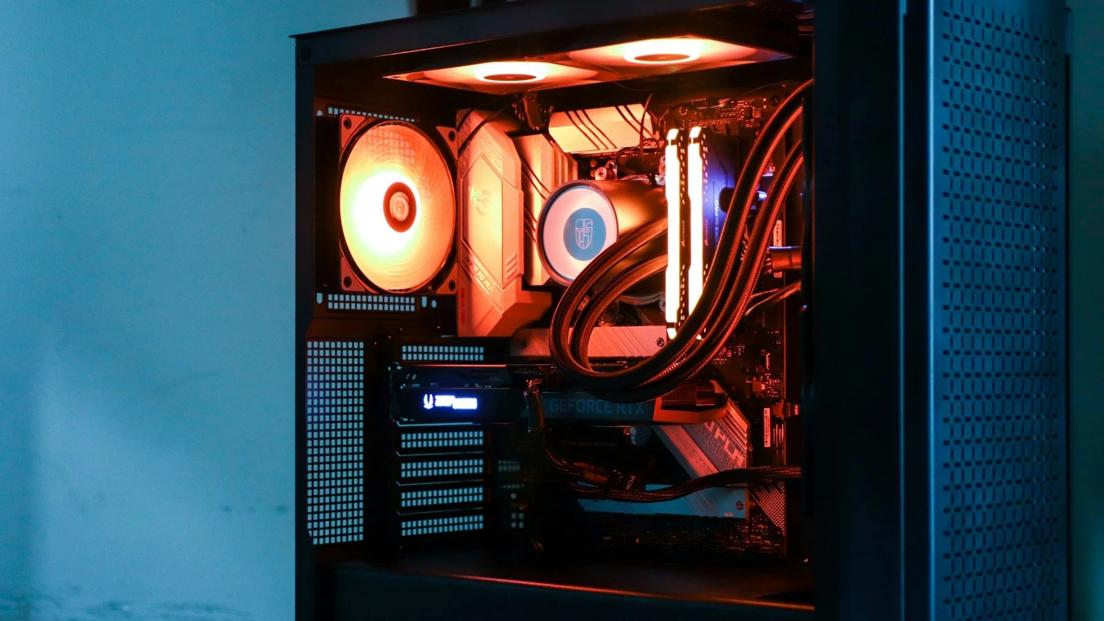 Inside a gaming PC with glowing fans and a liquid CPU cooler