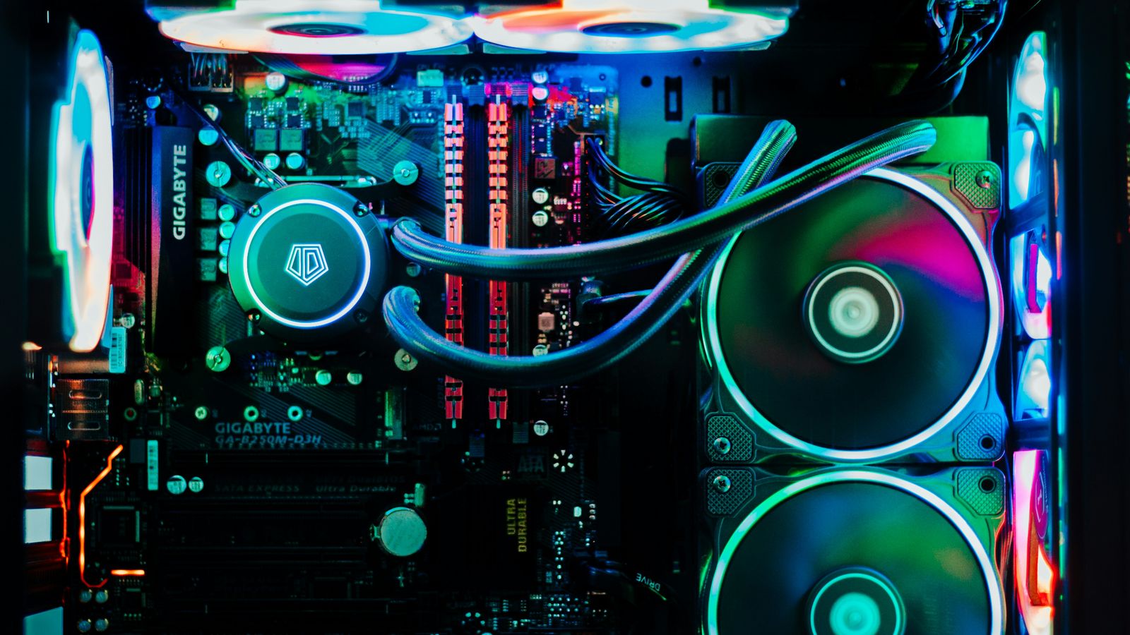 Inside of a desktop PC with RGB-lit fans, liquid cooling and memory